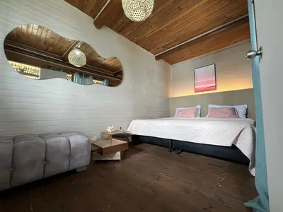 a bedroom with a bed and a couch at El Arca in Tintipan Island