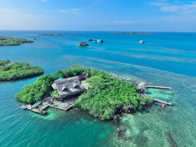 an island with a house on it in the water at El Arca in Tintipan Island