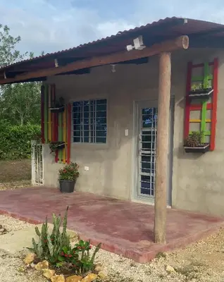 a small house with colorful windows and a porch at Cabañas Paulamar - Apto 4 - Tolú in Santiago