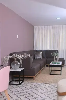 a living room with a couch and two tables at Apartahotel Edificio Baquero x10 Apto 403 in Barranquilla