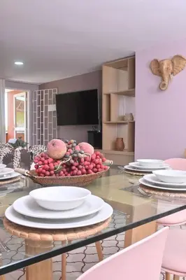 a table with plates and bowls of fruit on it at Apartahotel Edificio Baquero x10 Apto 403 in Barranquilla