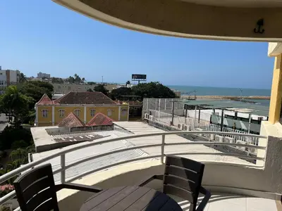 a balcony with chairs and a view of the ocean at Cabrero, cerca de la Ciudad Amurallada y playa in Cartagena de Indias