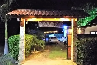 a driveway entrance to a house at night at Cabaña Maria José in Moñitos