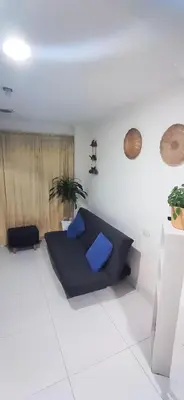 a living room with a blue couch in a room at Apartamento Amoblado Confortable in Cartagena de Indias
