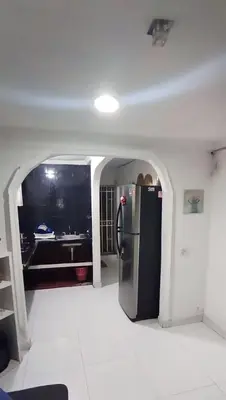 a kitchen with a refrigerator in the middle of a room at Apartamento Amoblado Confortable in Cartagena de Indias