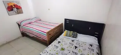 a small bedroom with a bed with a black headboard at Apartamento Amoblado Confortable in Cartagena de Indias