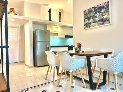 a kitchen with a table and chairs and a refrigerator at by Calamari Homes - Parque Centenario 202 walled city in Cartagena de Indias