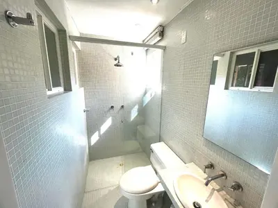 a bathroom with a toilet and a sink and a mirror at by Calamari Homes - Parque Centenario casa 206 walled city in Cartagena de Indias