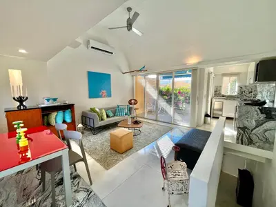 a living room with a couch and a table at by Calamari Homes - Parque Centenario casa 206 walled city in Cartagena de Indias