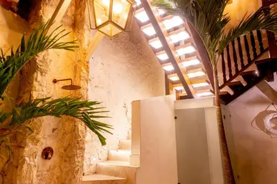 a hallway with stairs in a building with a ceiling at Palmas de Alba Hotel Boutique in Cartagena de Indias