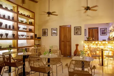 a restaurant with tables and chairs in a room at Palmas de Alba Hotel Boutique in Cartagena de Indias