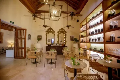 a restaurant with tables and chairs in a room at Palmas de Alba Hotel Boutique in Cartagena de Indias