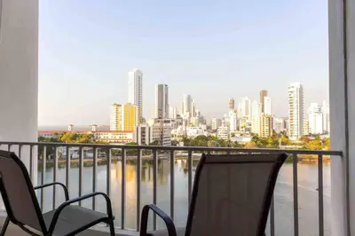 a balcony with two chairs and a view of a city at Prime Location: Fully Equipped Loft in El Laguito in Cartagena de Indias