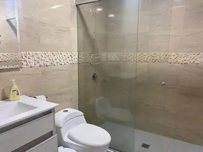 a bathroom with a shower and a toilet and a sink at Prime Location: Fully Equipped Loft in El Laguito in Cartagena de Indias