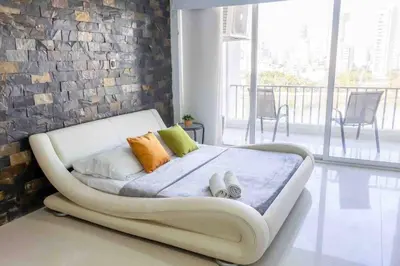 a white couch in a room with a brick wall at Prime Location: Fully Equipped Loft in El Laguito in Cartagena de Indias