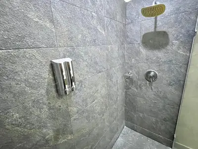 a bathroom with a shower with a phone on the wall at by Calamari Homes - Infinitum 3302 Bocagrande in Cartagena de Indias