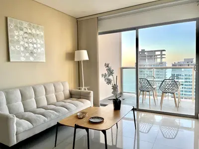 a living room with a couch and a table at by Calamari Homes - Infinitum 3302 Bocagrande in Cartagena de Indias
