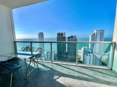 a balcony with a view of the ocean and buildings at by Calamari Homes - Infinitum 3302 Bocagrande in Cartagena de Indias