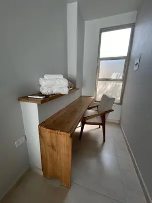a room with a wooden bench and a chair at DELAMAR Casa de playa in Coveñas