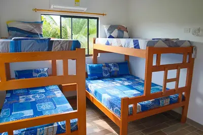 a room with three bunk beds and a window at CABAÑA PLAYA MAR in Coveñas