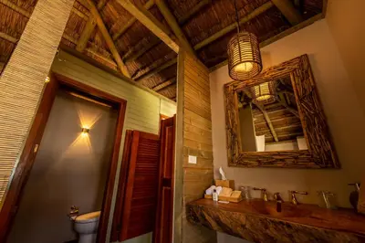 a bathroom with a sink and a mirror at ACASI Rustic Beach in Baru