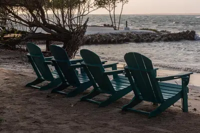 a group of chairs and a table on the beach at ACASI Rustic Beach in Baru