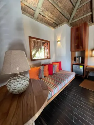 a living room with a couch and a table at ACASI Rustic Beach in Baru