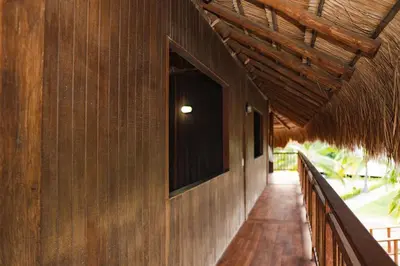 a hallway of a building with a straw roof at U-GO Espectacular Casa en Barú con Vistas al Mar in Cartagena de Indias