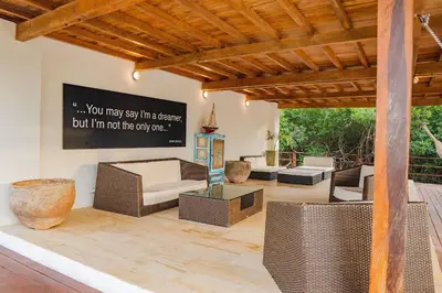 a living room with wicker furniture and a wooden ceiling at U-GO Espectacular Casa en Barú con Vistas al Mar in Cartagena de Indias