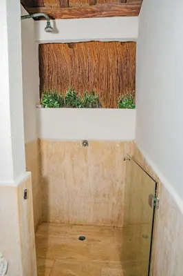 a bathroom with a shower and a window with grass at U-GO Espectacular Casa en Barú con Vistas al Mar in Cartagena de Indias