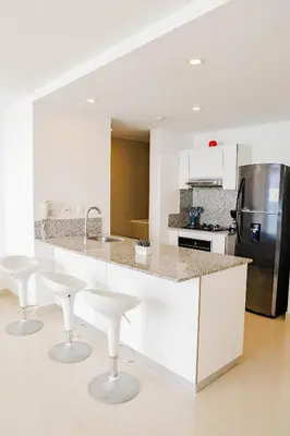 a kitchen with a white counter and a refrigerator at U-GO Morros City Bocagrande Frente al Mar in Cartagena de Indias