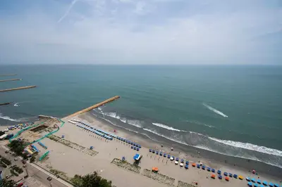 an aerial view of a beach with umbrellas and the ocean at U-GO Morros City Bocagrande Frente al Mar in Cartagena de Indias