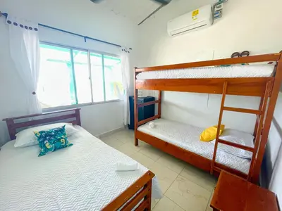 a bedroom with two bunk beds and a window at Cabaña Tierramia 1 in San Silvestre
