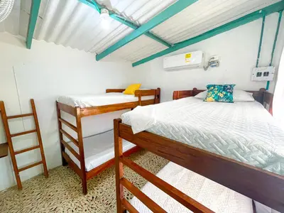 a bedroom with two bunk beds and a ladder at Cabaña Tierramia 1 in San Silvestre