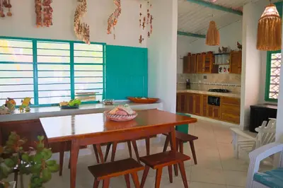 a kitchen with a wooden table and chairs in it at Cabaña Tierramia 1 in San Silvestre