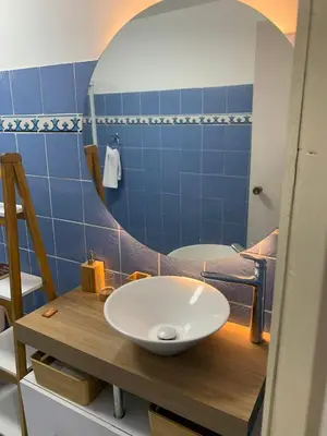 a bathroom with a white sink on a wooden counter at Apartahotel Edificio Baquero x5 Apto 401 in Barranquilla