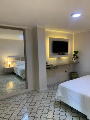 a hotel room with a bed and a television at Apartahotel Edificio Baquero x5 Apto 401 in Barranquilla