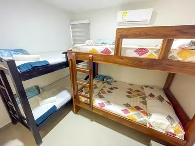a room with two bunk beds and a bed at Apartamento Arenita de mar in Coveñas