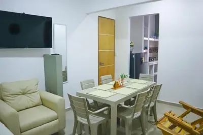 a dining room with a table and a chair at Apartamento Arenita de mar in Coveñas