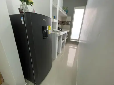 a kitchen with a black refrigerator in a room at Apartamento Arenita de mar in Coveñas