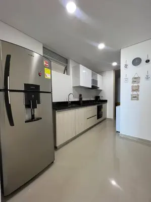 a large kitchen with a refrigerator in a room at Moderno y amplio apartamento cerca a la playa! in Cartagena de Indias