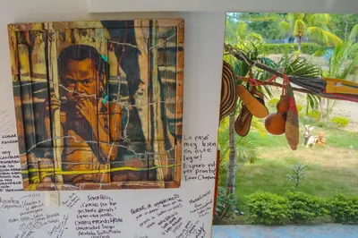 a book with a picture of a boy in a window at Hotel - Granja de Animales San Basilio de Palenque in San Basilio del Palenque