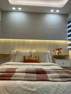 a bedroom with a large bed with a wooden headboard at Nice Apartment close to Historic City and beach in Cartagena de Indias