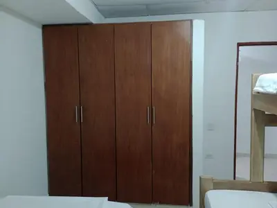 a room with wooden cabinets in a bedroom at Apartamentos Poseidon in Coveñas