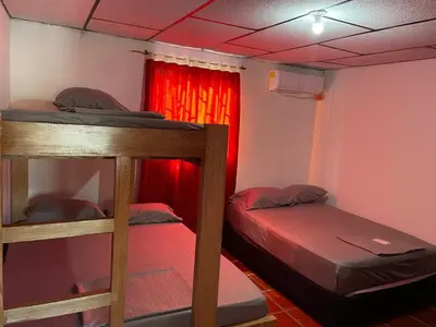 two bunk beds in a room with a red curtain at Apartamentos Poseidon in Coveñas