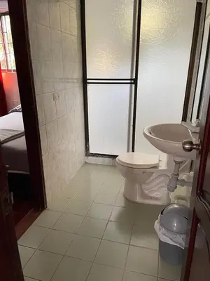 a bathroom with a toilet and a sink and a shower at Apartamentos Poseidon in Coveñas
