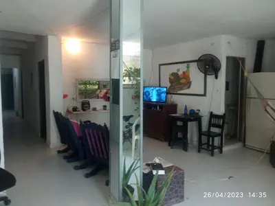 a living room with chairs and a glass wall at Hostal Sol in Cartagena de Indias