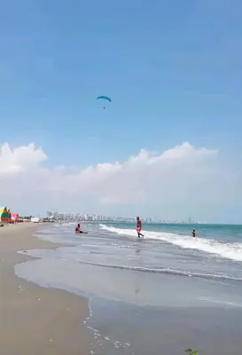 a group of people playing in the water at the beach at Hostal Sol in Cartagena de Indias