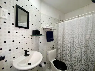 a white bathroom with a sink and a toilet at Habitación Cerca de aeropuerto in Cartagena de Indias
