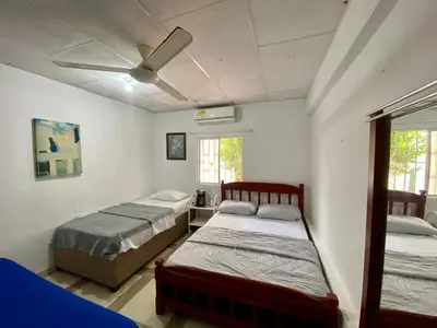 a bedroom with two beds and a ceiling fan at Habitación Multiple cerca de aeropuerto in Cartagena de Indias